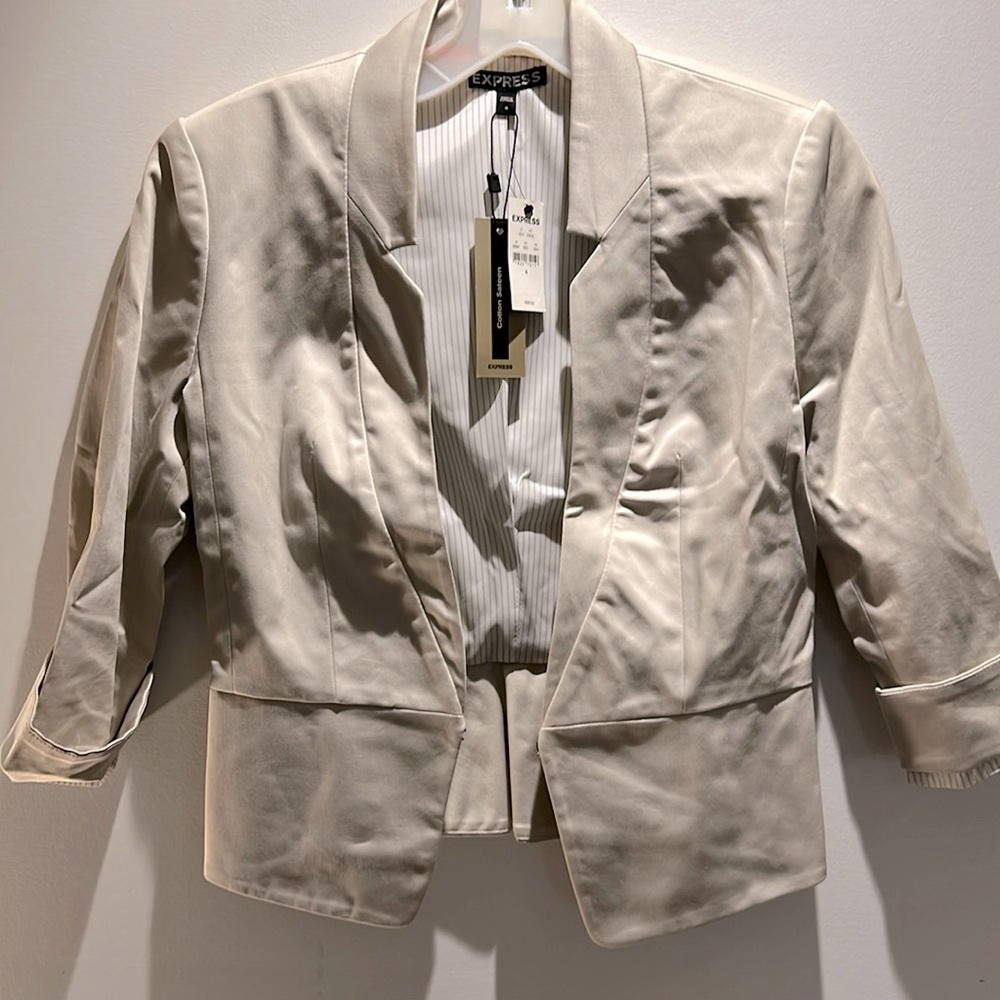 Beige, tailored-cut, V-neck blazer. New with tag, lining and hook closure.
